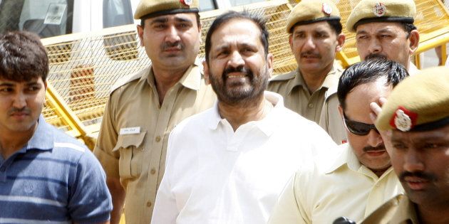 Former chairman of CWG organising committee, Suresh Kalmadi (C) is escorted by Central Bureau of Investigation (CBI) officials to the court in New Delhi.