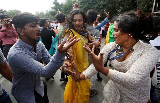 People dance on the streets in Mumbai.