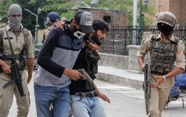 A policeman dressed as a stone pelter arrests a Kashmiri protester during clashes in Srinagar on 7 September.