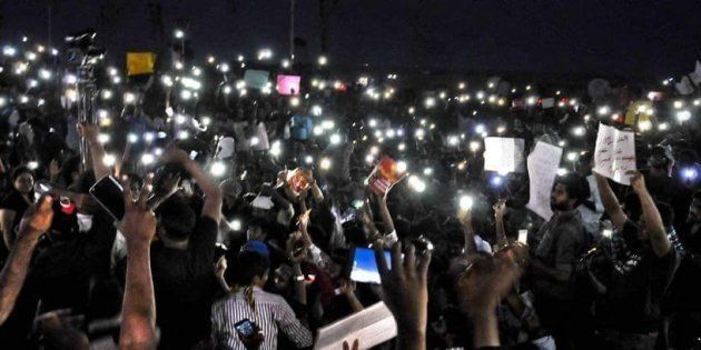 Hundreds of protestors at Chennai's Marina beach hold up their mobile phones while protesting against the ban on Jallikattu on Tuesday night, 17 January, 2017.
