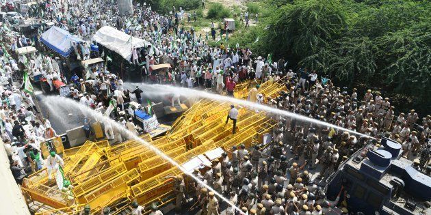 New Delhi police use water canons to disperse and stop farmer activists of the Bhartiya Kisan Union at the border with Ghazipur during their march to New Delhi on October 2, 2018
