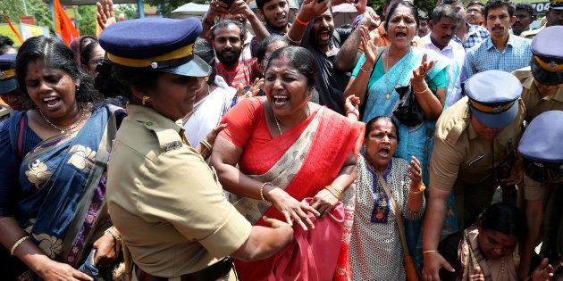 A woman being detained by a police officer during a protest called by various Hindu organisations against the Supreme Court's order lifting the ban on women's entry into Sabarimala.