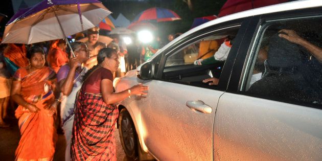 Women in favour of barring women of menstruating age from entering the Sabarimala temple scan vehicles at Nilakkal, the base camp on way to Sabarimala temple, on Tuesday.