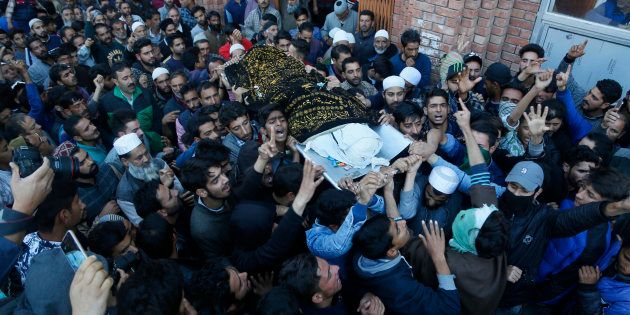 Kashmiri villagers carry the body of Uzair Mushtaq during his funeral in Kulgam 75 Kilometers south of Srinagar, Indian controlled Kashmir, Sunday, Oct. 21, 2018. Three local rebels were killed in a gunbattle with Indian government forces in disputed Kashmir on Sunday, and six civilians were killed in an explosion at the site after the fighting was over, officials and residents said. (AP Photo/Mukhtar Khan)
