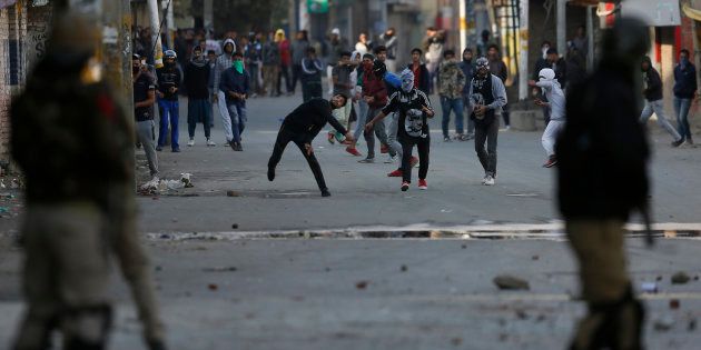 Kashmiri protesters throw stones at Indian policemen in Srinagar on Monday.