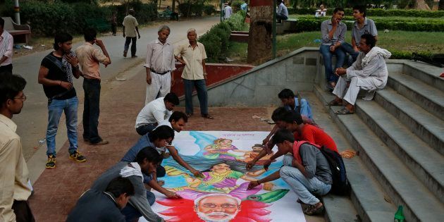 Students make a poster urging Prime Minister Narendra Modi to save the Ganga in Allahabad.