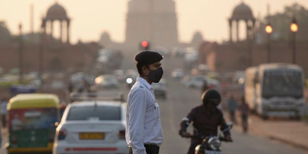 A traffic cop in Delhi wears a mask to protect himself from the pollution.