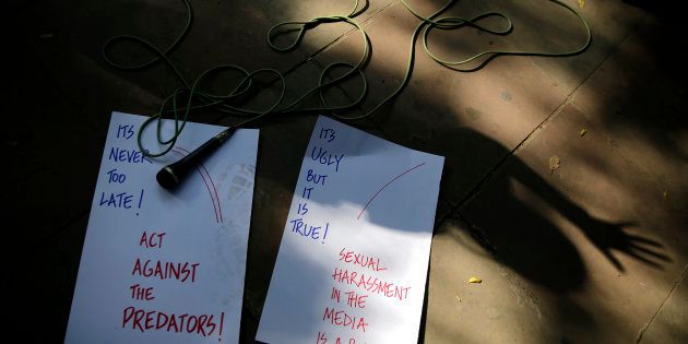 Placards and a microphone are seen lying on the sidewalks as Indian journalists protest against sexual harassment in the workplace in New Delhi, India, Saturday, Oct. 13, 2018.
