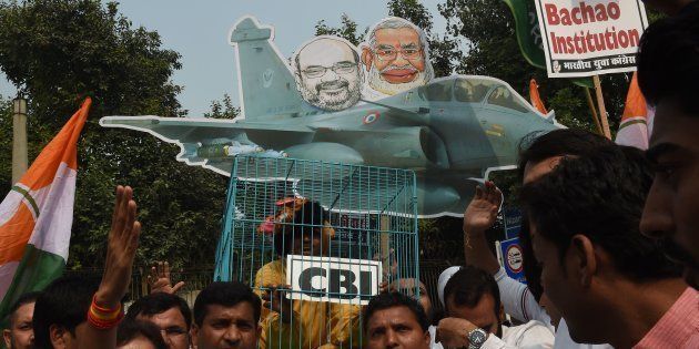 Supporters and members of the Congress party take part in a protest featuring an image of Prime Minister Narendra Modi and a Rafale fighter jet in New Delhi on October 26, 2018.