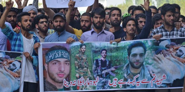 People raise slogans during a protest inside the Kashmir University campus on the second death anniversary of Burhan Wani.