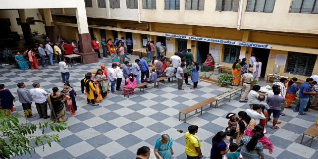 File photo of Voters waiting in queues to cast their ballot outside a polling station during the recently concluded Karnataka assembly elections.