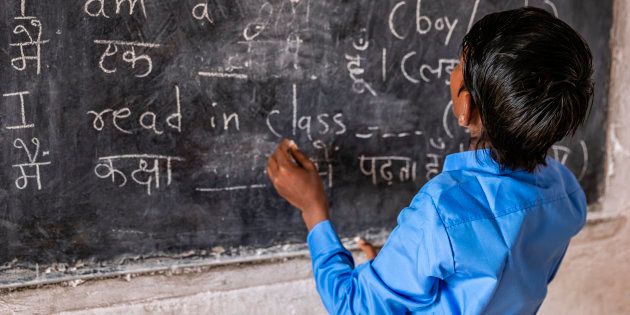 Indian schoolboy in classroom, English language class, Rajasthan, India