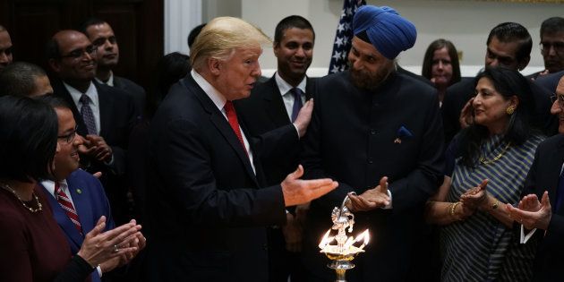 US President Donald Trump speaks as Indian Ambassador to the US Navtej Singh Sarna looks on during a Diwali ceremony in the Roosevelt Room of the White House.