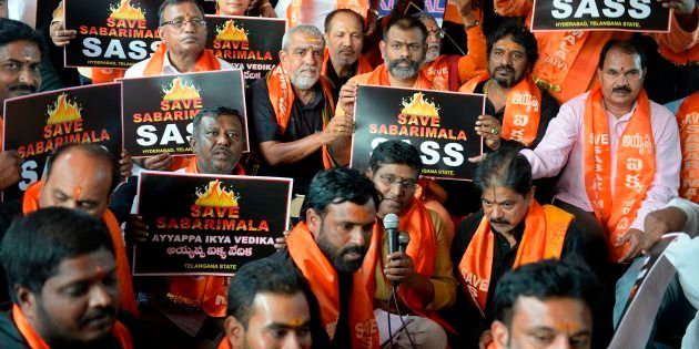 Members of the Sabarimala Ayyappa Seva Samajam hold placards during a protest in Hyderabad on 20 November.
