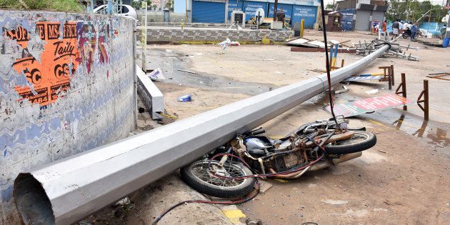 A fallen pole and a damaged motorbike are seen on a road after Cyclone Gaja hit Velankanni.