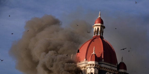 Smoke billows from under the main dome of the Taj Palace Hotel in Mumbai on 27 November
