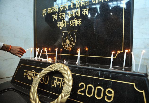 People light candles at a memorial for the 2008 Mumbai attack victims at the Chhatrapati Shivaji Terminus railway station, on 6 May 2010, the day Kasab's sentence was pronounced.