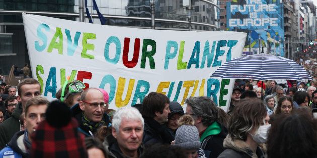 People take part in a march called 'Claim the Climate' in Brussels, Belgium On 2 December, 2018.