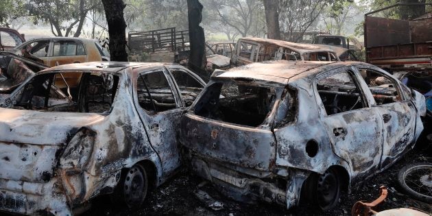 Cars lie vandalised near a police station after a mob attack in Bulandshahr.