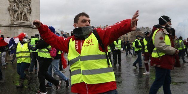 Yellow vest protesters clash with riot police as part of demonstration against rising fuel taxes.