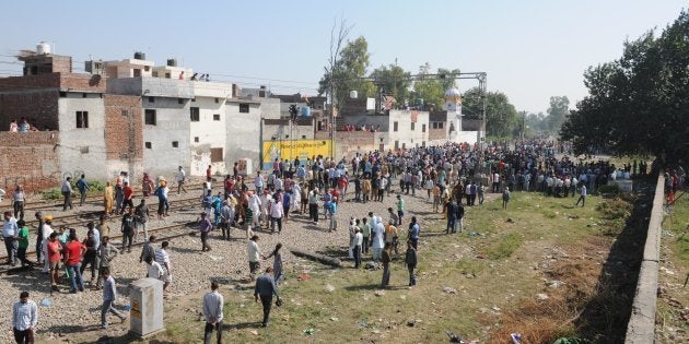 Punjab Police personnel and local people gather at the scene of the accident.