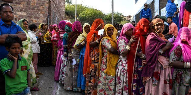 Women stand in queue to cast their vote at a local polling station on 7 December.