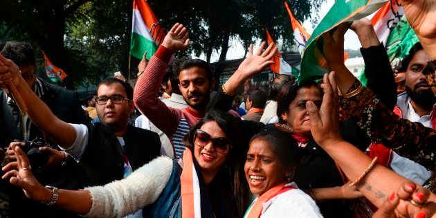 Congress supporters celebrate outside the party headquarters in New Delhi.