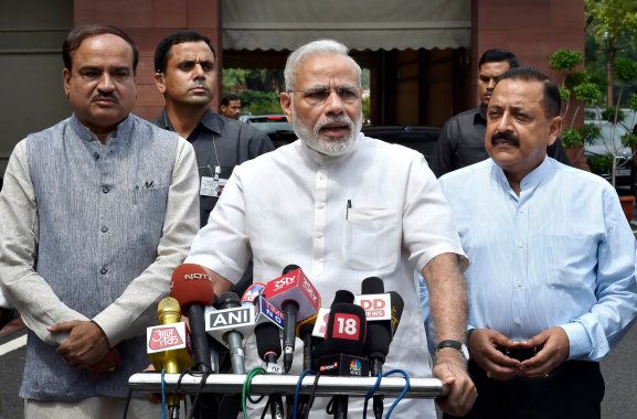 Prime Minister Narendra Modi talks to the media with his cabinet colleagues after his arrival at the opening day of the Monsoon Session of the Parliament, on July 18, 2016 in New Delhi.