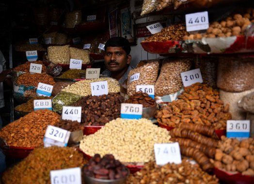 An Indian vendor works in his shop in the old quarters of New Delhi on 2 August, 2016.