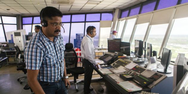 Air-traffic controllers work inside a control tower at Indira Gandhi International Airport (IGI) in Delhi, India