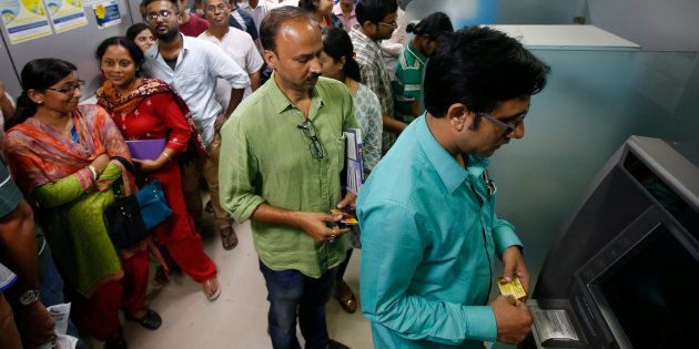 People wait to withdraw and deposit their money at an ATM kiosk in Kolkata, India, November 8, 2016.