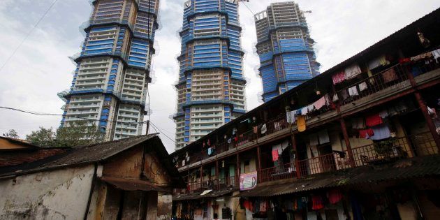 High-rise residential towers under construction are pictured behind an old residential building in central Mumbai.
