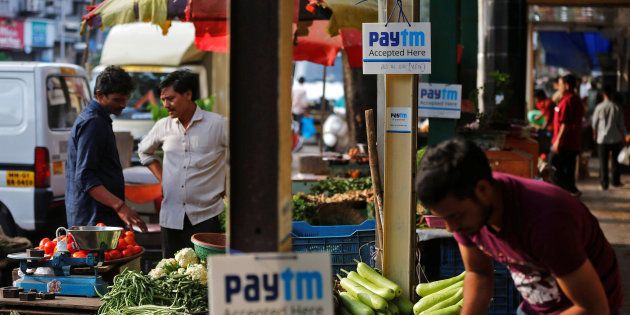 Advertisement boards of Paytm, a digital wallet company, are seen placed at stalls of roadside vegetable vendors as they wait for customers in Mumbai, India, November 19, 2016. Picture taken November 19, 2016. REUTERS/Shailesh Andrade