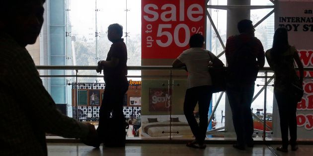 Representative image. Shoppers are silhouetted as they stand near a sign advertising a sale at a shopping mall in Mumbai February 11, 2013.