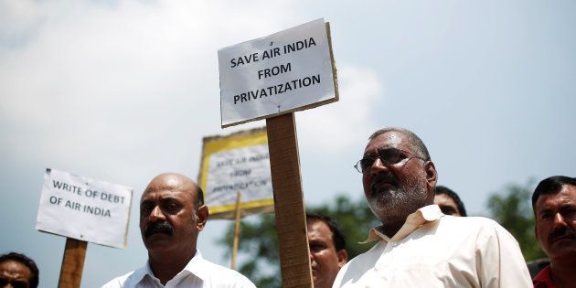 Air India employees hold placards as they shout slogans during a protest against the proposed privatisation of Air India by the government, in New Delhi.
