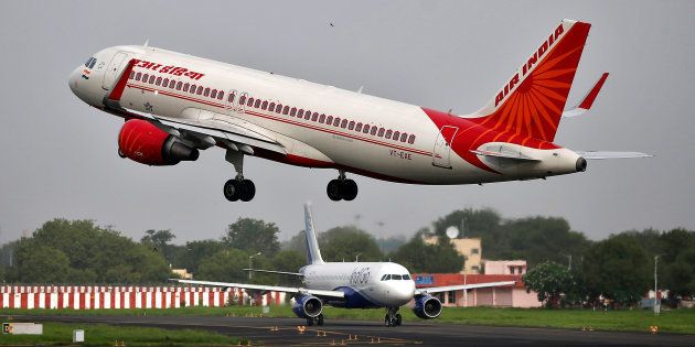 An Air India aircraft takes off as an IndiGo Airlines aircraft waits for clearance at the Sardar Vallabhbhai Patel International Airport in Ahmedabad.