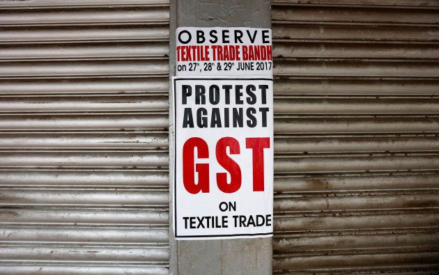 A poster is pictured on closed garment shops during a protest against implementation of Goods and Services Tax (GST) on textiles in Kolkata.