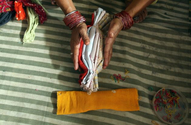 Indian woman makes cloth sanitary napkins at the NGO Goonj in New Delhi, 10 September 2007.