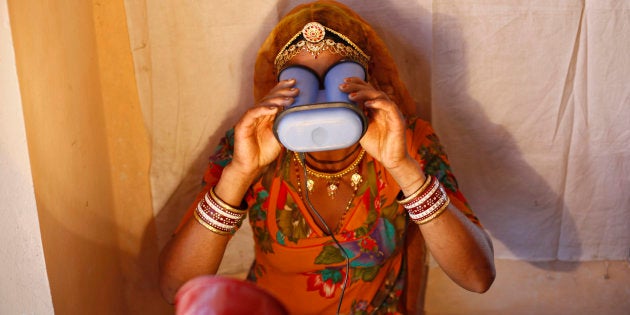 A villager goes through the process of eye scanning for Unique Identification (UID) database system at an enrolment centre at Merta district in the desert Indian state of Rajasthan February 21, 2013.In a more ambitious version of programmes that have slashed poverty in Brazil and Mexico, the Indian government has begun to use the UID database, known as Aadhaar, to make direct cash transfers to the poor, in an attempt to cut out frauds who siphon billions of dollars from welfare schemes. Picture taken February 21, 2013. REUTERS/Mansi Thapliyal (INDIA - Tags: BUSINESS SOCIETY POVERTY SCIENCE TECHNOLOGY)