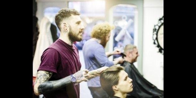 Barber styling young mans hair