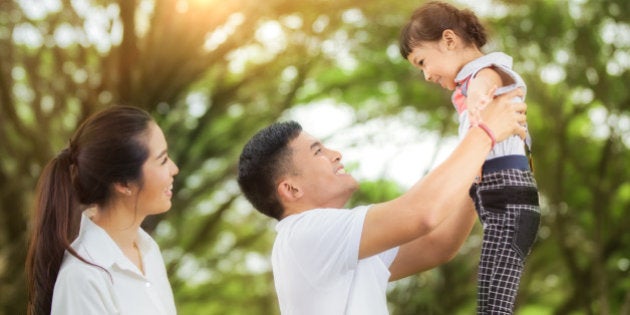 happy asian young family spending time outdoor on a summer day