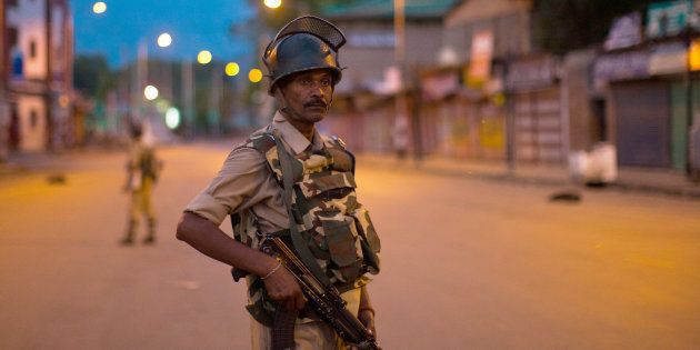 SRINAGAR, KASHMIR, INDIA - JULY 10: Security forces stand guard in the city centre, during curfew after 21 people were killed and more than 400 Injured on July 10, 2016 in Srinagar, the summer capital of Indian Administered Kashmir.