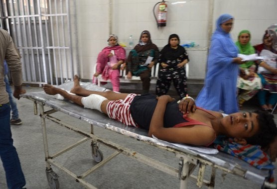 An injured Indian Kashmiri youth who was shot during clashes between security forces and protesters is brought into a hospital in Srinagar on July 10, 2016.