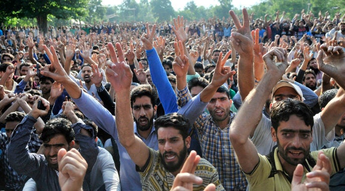 SRINAGAR, INDIA -JULY 9: Kashmiri people gather during a funeral procession of Hizbul Mujahideen commander Burhan Wani in his hometown in Tral some 40 kms from Srinagar, on July 9, 2016 in Srinagar, India.