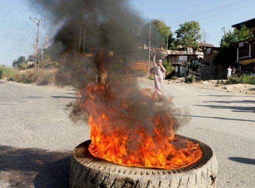 SRINAGAR, INDIA -JULY 9: Protesters burn tyres against the killing of Hizbul Mujahideen commander Burhan Wani on the Jammu-Srinagar highway, on July 9, 2016 in Srinagar, India.