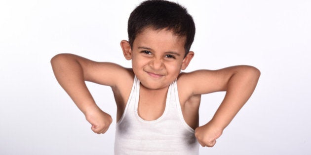 Young child showing his muscles