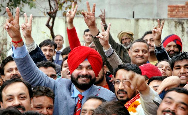 Former cricketer and politician Navjot Singh Sidhu (in red turban) gestures to his supporters in Amritsar February 27, 2007.