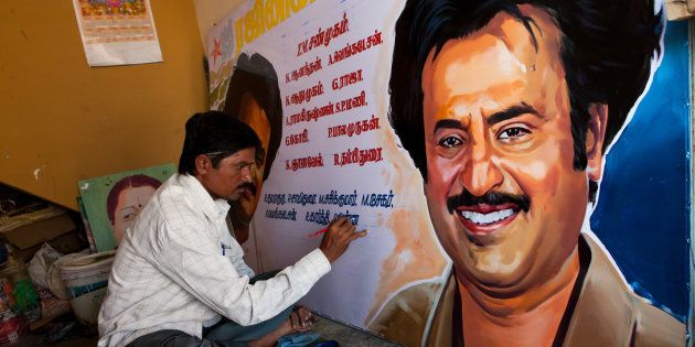 An artist working on a poster of Rajnikanth.