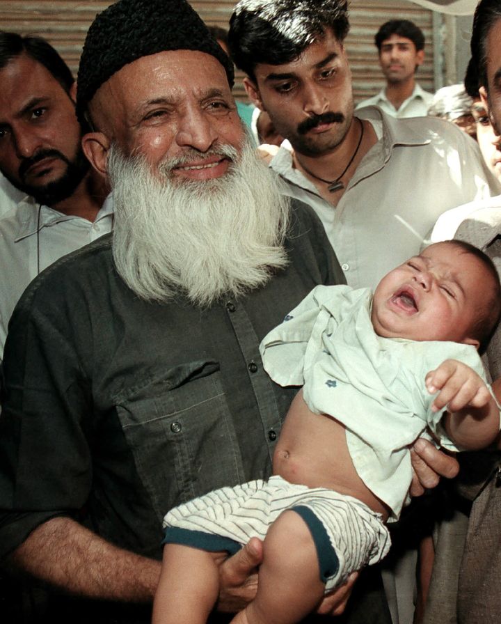 Abdul Sattar Edhi holds a child
