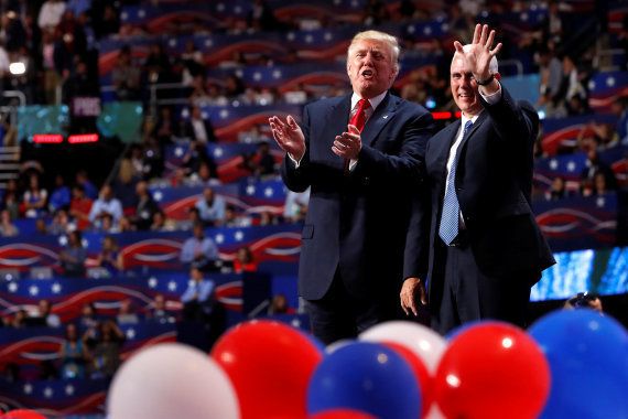 Republican U.S. presidential nominee Donald Trump and vice presidential nominee Governor Mike Pence (R) stand amid balloons onstage at the end of the final session of the Republican National Convention in Cleveland, Ohio, U.S. July 21, 2016. REUTERS/Aaron P. Bernstein TPX IMAGES OF THE DAY